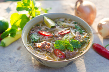 Pho Bo - Vietnamese fresh rice noodle soup with beef, herbs and chili. Vietnam's national dish.