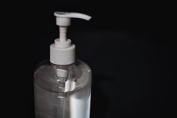 Hand sanitizer bottle with black background.