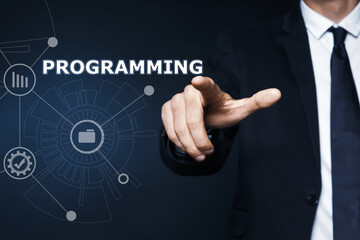 Businessman pointing at word PROGRAMMING on virtual screen, closeup