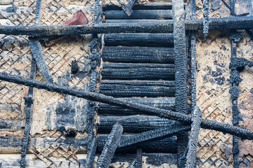 Part of the charred wall of an apartment building after a fire