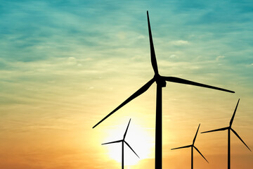 Silhouettes of wind turbines at sunset. Alternative energy source