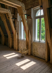 Fototapeta na wymiar wooden beams and windows in the roof attic