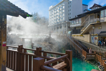 people sightseeing at Yubatake Hotspring with evening light in Gunma ,Japan 