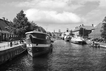 Ships and yachts on the canal in Copenhagen. Denmark. Black and white photo. Architecture. Transport.