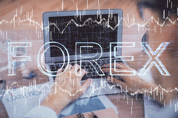 Multi exposure of market chart with man working on computer on background. Concept of financial...