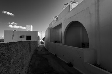 Streets and courtyards of the white city of Oia on the island of Santorini. Greece.