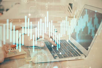 Double exposure of stock market graph with man working on laptop on background. Concept of financial analysis.