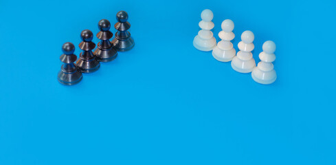 Black and white chess pieces on a blue background. Stop racism. Black lives matter! Motivational poster against racism and discrimination. High quality photo