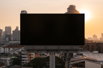 Obraz premium Blank black road billboard with Bangkok cityscape background at sunset. Street advertising poster, mock up, 3D rendering. Front view. The concept of marketing communication to promote or sell idea.