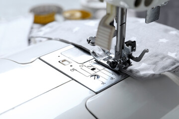Sewing machine with homemade protective mask, closeup