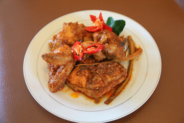 Photos of chicken food cooked spicy and served on a plate