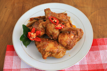 Photos of chicken food cooked spicy and served on a plate