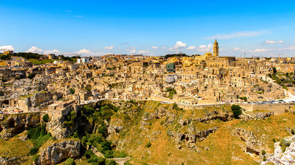 Fototapeta na wymiar It's Panoramic view of Matera, Puglia, Italy. The Sassi and the Park of the Rupestrian Churches of Matera. UNESCO World Heritage site