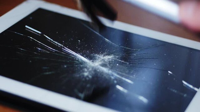 Hammer smashes a computer tablet in slow motion