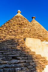 Fototapeta na wymiar It's Typical trulli houses of Alberobello, a small town in Apulia, Italy. The Trulli of Alberobello have are a UNESCO World Heritage site since 1996