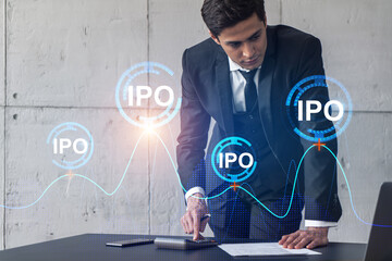 Businessman signs contract and ipo hologram. Double exposure. Formal wear. Concept of market analysis.