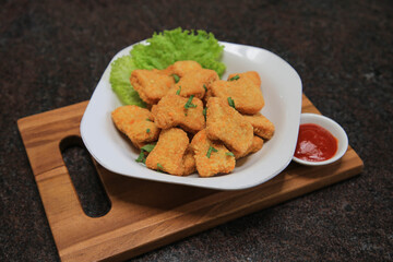 Chicken nuggets serve with saur on wooden boards