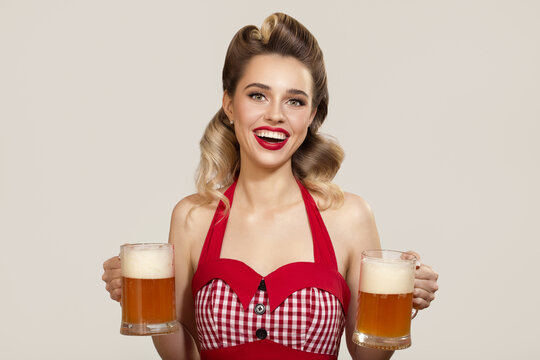 Smiling pin-up girl holding two glasses of beer in her hands