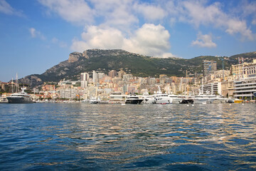 View from the Mediterranean sea of the Principality of Monaco, and Monte Carlo, with dense skyscrapers , the marina, yachts, palace & casino. 
