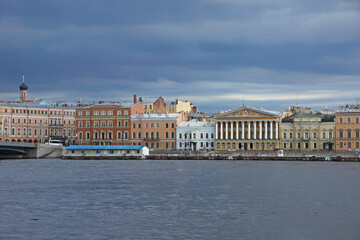 Naklejka premium View accross the Neva river, which is one of the main waterways of the city, and historic colurful buildings on the other side, St Petersburg, Russia.