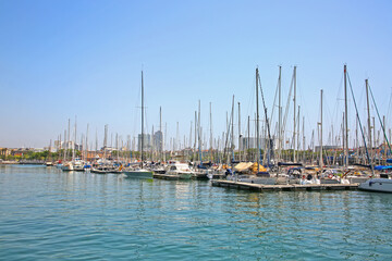 View from Rambla De Mar of the marina & many yacths moored at Port Vell which is a waterfront harbor and part of the Port of Barcelona, Catalonia, Spain.