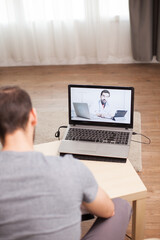 Male patient in a video conference with his doctor during quarantine.