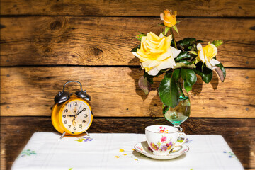 Tea Time: Cup of tea and flowers on wooden background