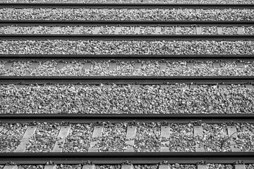 Group of parallel train tracks. Black and white.