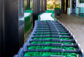 Group of trolleys lined up outside the supermarket, ready to be used without the use of coin