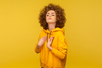 I am the best! Portrait of egoistic selfish curly-haired woman in urban style hoodie pointing...
