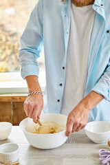 Man, male forming the dough in Bowl a and kneading at home