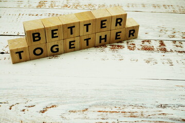 Better Together alhpabet letter on wooden bakground