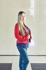 portrait of young girl. blond woman in red jacket