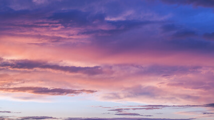 Naklejka na ściany i meble Summer sunset. Evening sky with orange clouds.