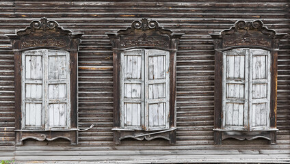 Shuttered windows of an old wooden residential building