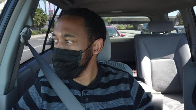 Black Man On Passenger Side Wearing A Face Mask On.