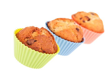 Chocolate and banana muffins in pastel silicon cake cases isolated against a white background. 