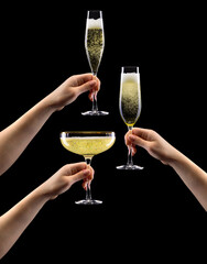 Set of hands holding glass of sparkling champagne isolated on black.