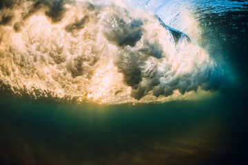 Ocean wave with vortex. Sea underwater with sunrise or sunset tones