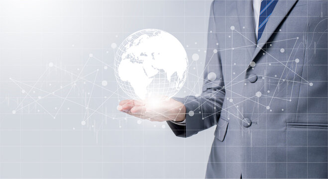 Businessman holding global data network and analyzing trend data and economic growth. Technology and business strategy. Digital marketing on interface hologram screen.
