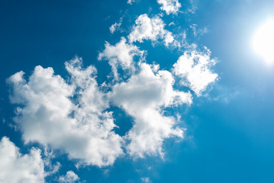 Blue sky with clouds and sun nice outdoor sunny day background.