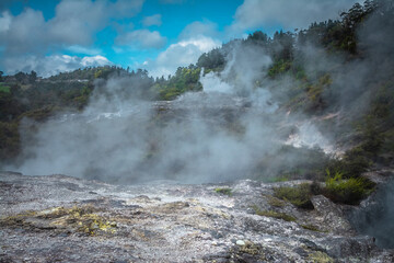 Smoking ground s- steam rising over geothermal area in mountains near Rotorua