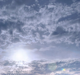Full frame background of grey sky and sunshine. 