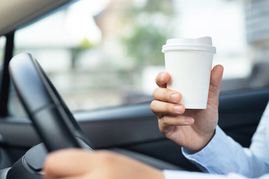 Man Is Drinking Hot Coffee In The Car Before Going To Work At The Office Every Time.