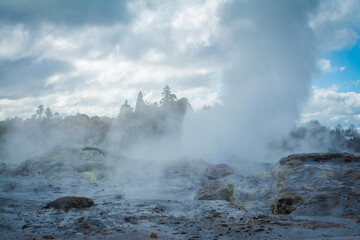 Geyser field with active geysers amongst rocks