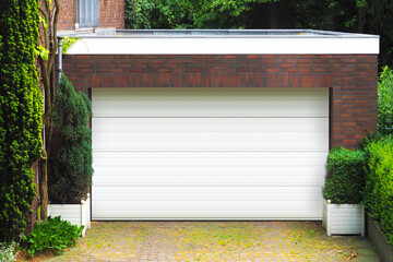 Garage concept. Brick car garage with closed white door