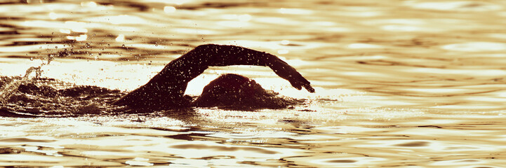 Silhouette man triathlon iron man athlete swimmers swimming
