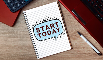 Notebook with text START TODAY. Notebook on desk with laptop and a pen.