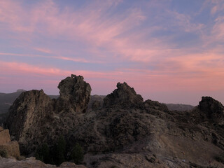 Sunset and pink sky at Roque Nublo the volcanic rock
