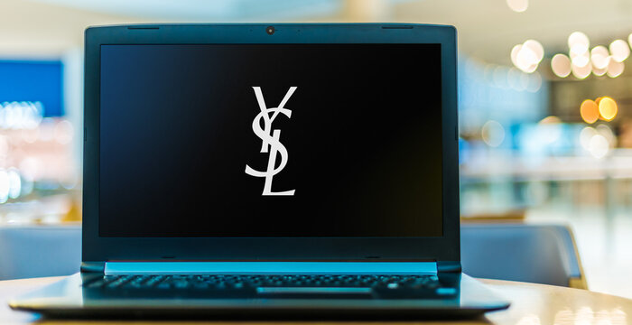 Laptop computer displaying logo of Yves Saint Laurent